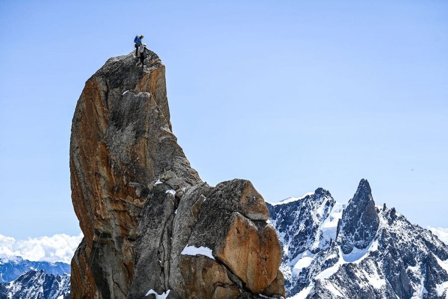 TOPSHOT - Members of the Chamonix guides company take part in a special hike, between France and Italy near the Mont Blanc mountain, on July 10, 2021, to celebrate the 200th anniversary of the high mountain association.

 montain climing party in the world at l'aiguille du Midi the 10 july,2021 at Chamonix Mont Blanc. - The company of Chamonix guides, the founding institution of mountaineering, celebrates its 200th anniversary on July 10, 2021 with the installation of a roped party of 200 people between the Aiguille du Midi and the Helbronner point, by the Italian border, above 3,000 m altitude, AFP journalists observed. (Photo by OLIVIER CHASSIGNOLE / AFP) (Photo by OLIVIER CHASSIGNOLE/AFP via Getty Images)